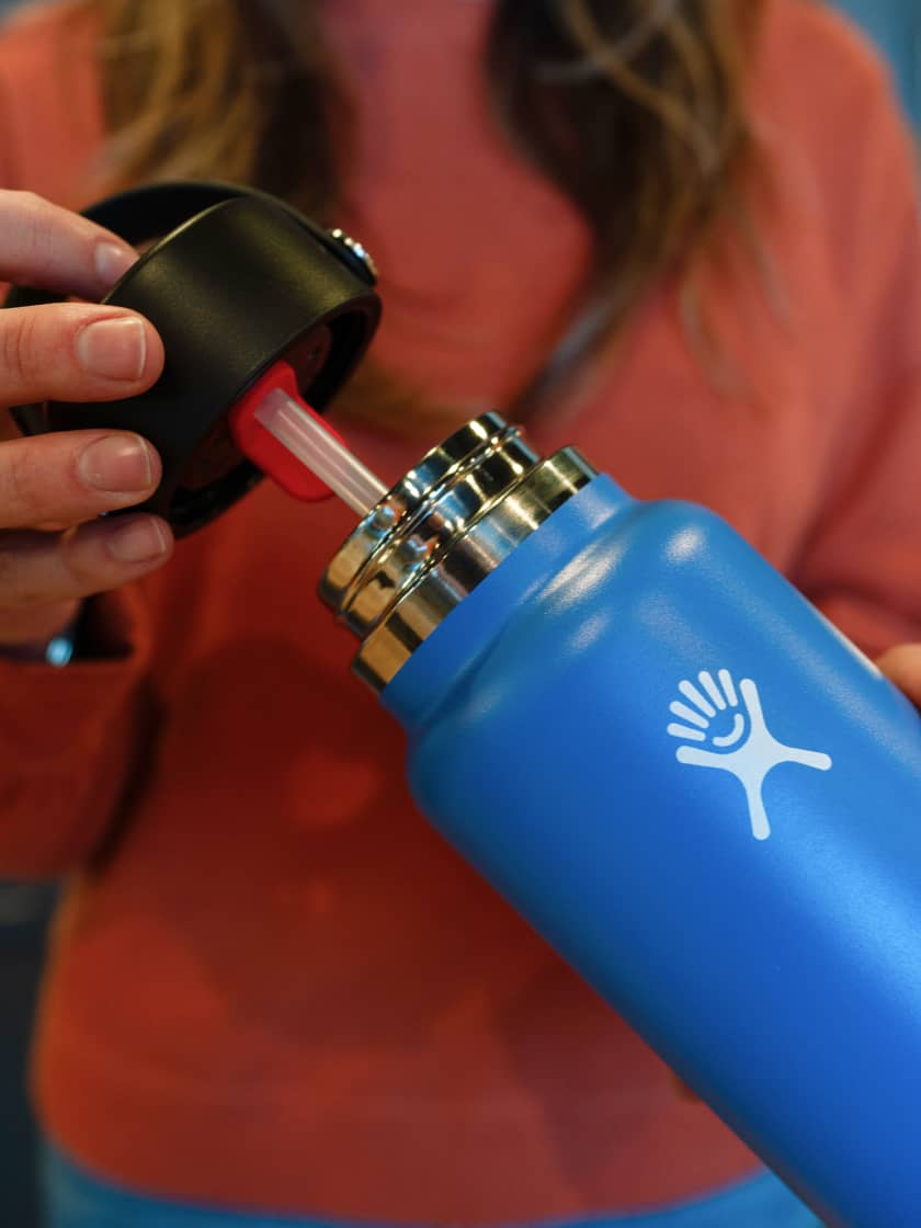 Hydro Flask water bottle straw cap being inserted into the bottle